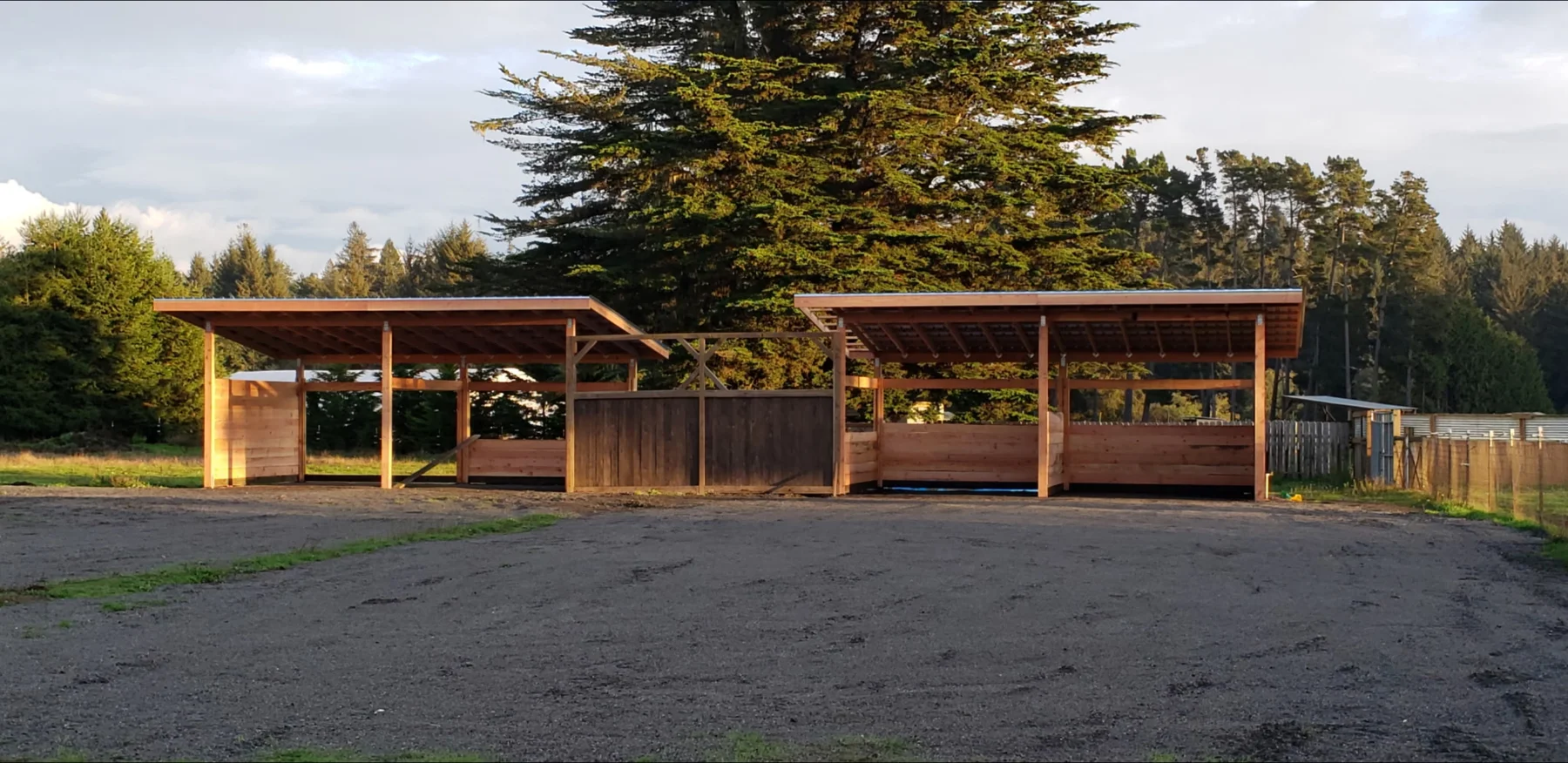 Two timber shelter structures facing an open central area